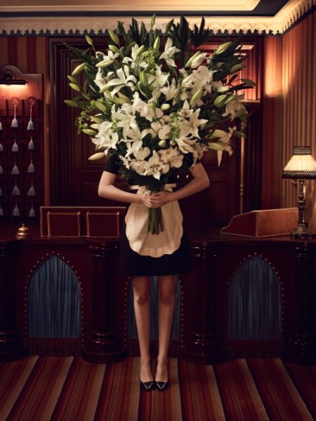 IMAGE: Abstract photo of maid with bouquet of white flowers at Hôtel Bourg Tibourg for hip hotels feature