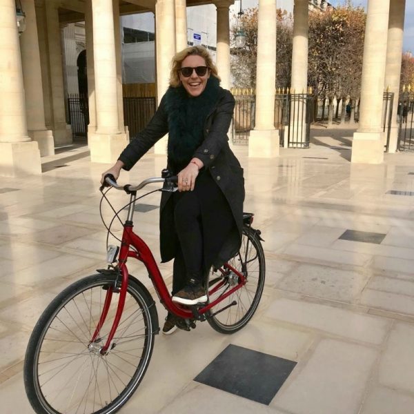 IMAGE: Founder and CEO of VINGT Paris, Susie Hollands, on her bicycle in Paris