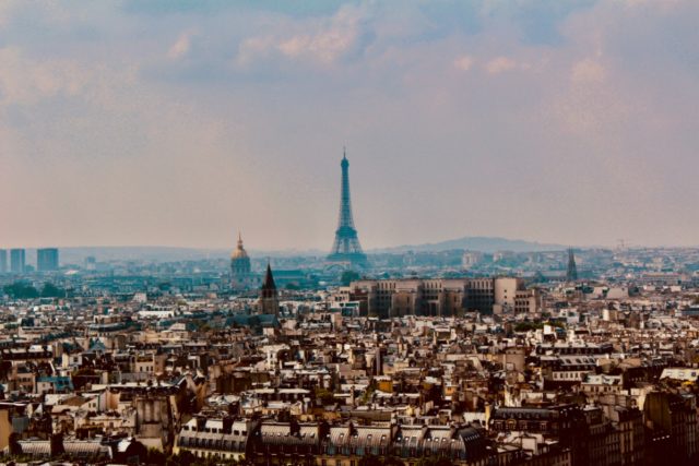 Photo showing aerial view of the Eiffel Tower and Paris to illustrate an article on relocation services